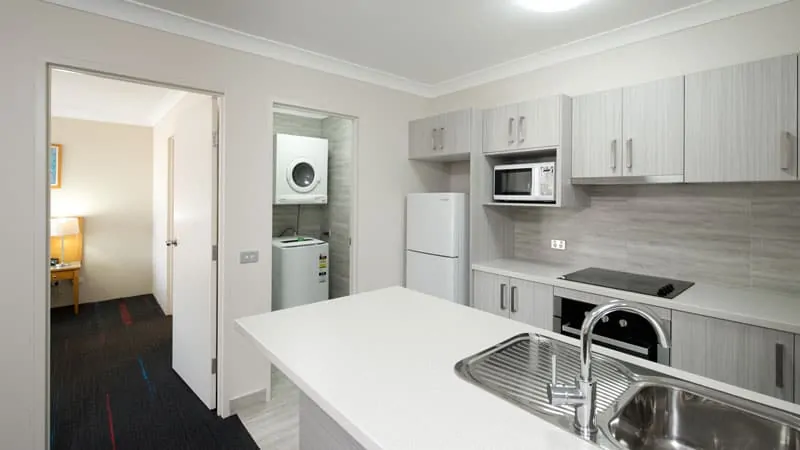 APX Hotels Apartments Parramatta has a classy kitchen and laundry area in Parramatta CBD Australia