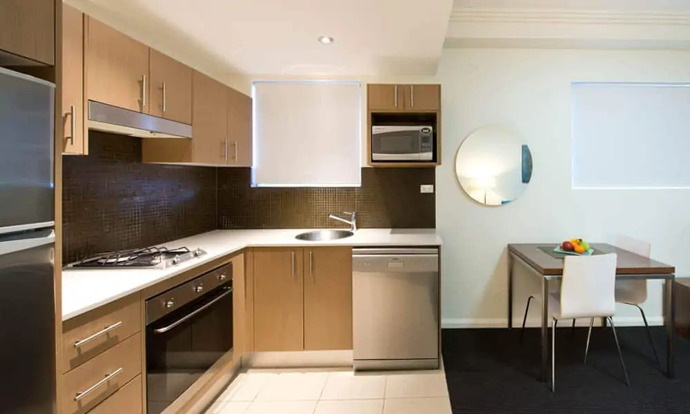 APX World Square affordable executive studio apartments kitchen counter and dining area in APX Hotels Apartments Sydney Australia