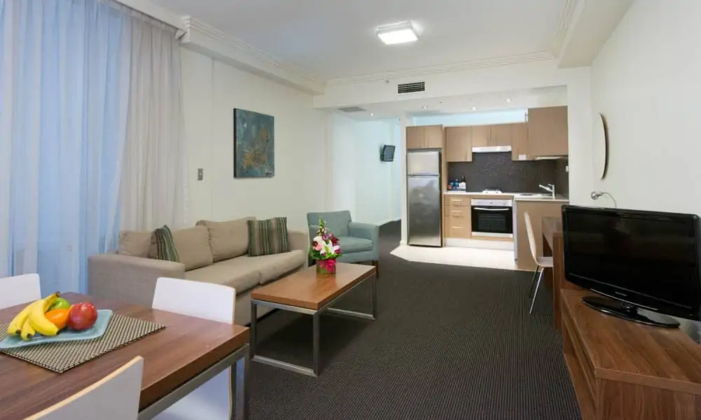 APX World Square clean comfortable and elegant executive studio apartments living dining and kitchen area in APX Hotels Apartments Sydney Australia
