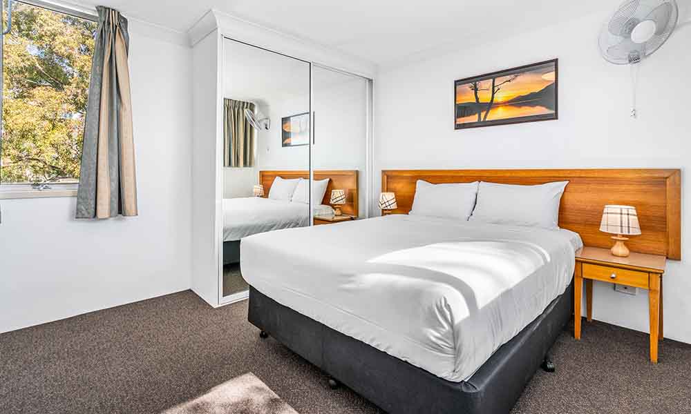 Queen bed in 1 Bedroom apartment at APX Hotels Apartments Parramatta | affordable accommodation in Parramatta CBD Australia