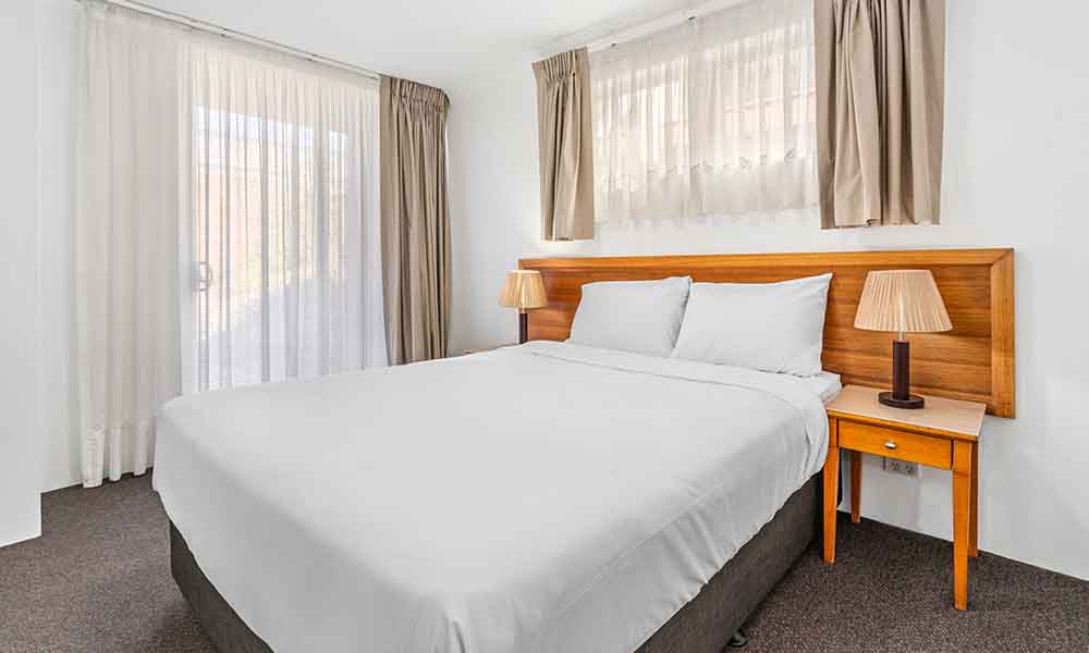 Queen bed APX Hotels Apartments Parramatta affordable one bedroom apartment accommodation in Parramatta CBD Australia